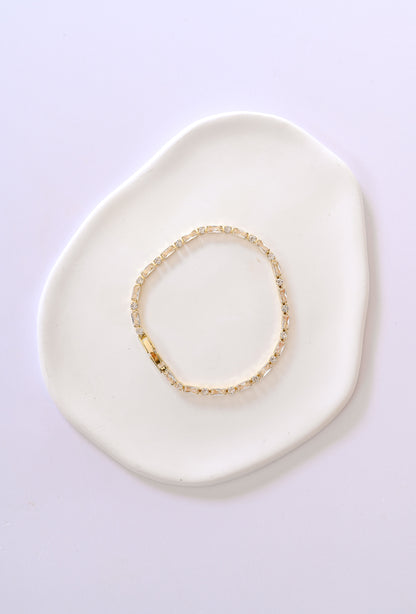 Delicate gold bridal bracelet with baguette and square shaped cubic zirconia.