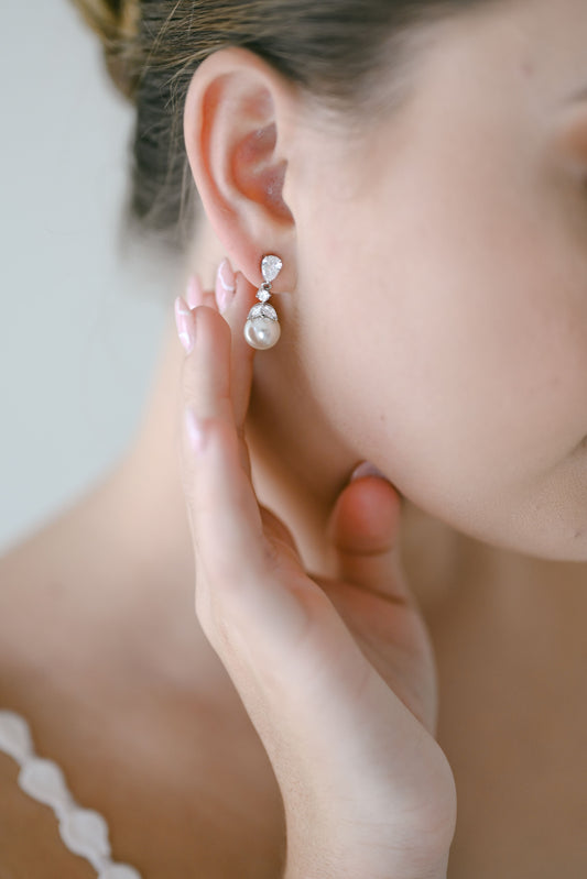 Bride wearing cubic zirconia and pearl drop earring