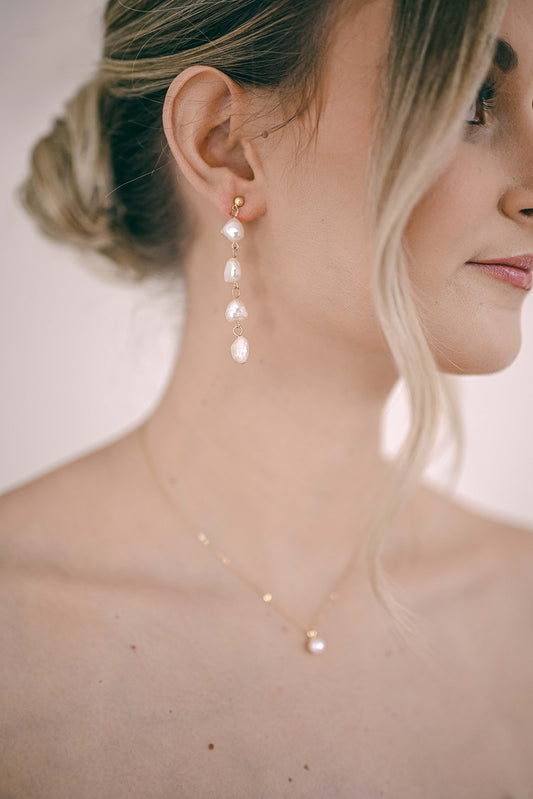 Bride wearing a string of pearls earrings