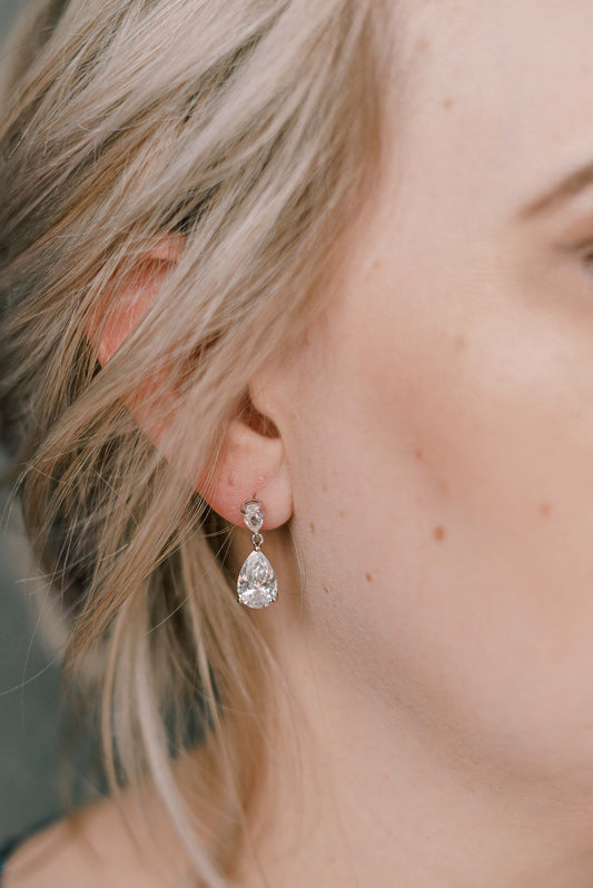 Bride wearing dainty silver cubic zirconia earring