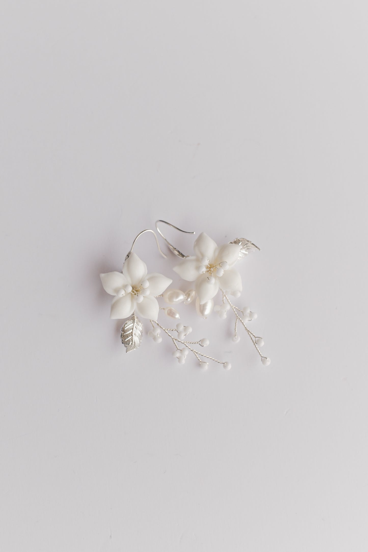 Pair of silver bridal earrings with porcelain flowers, fresh water pearls and beads