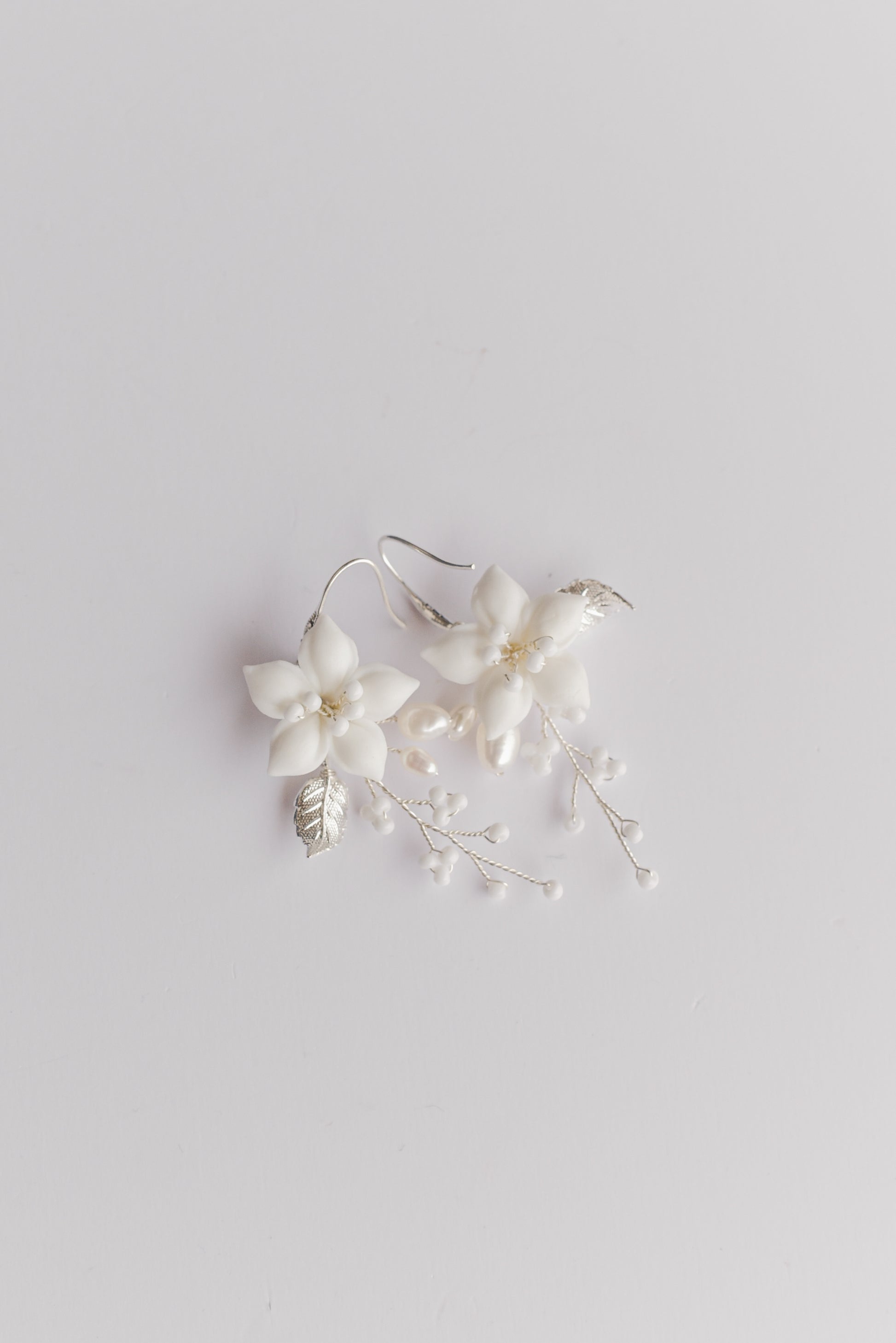 Pair of silver bridal earrings with porcelain flowers, fresh water pearls and beads