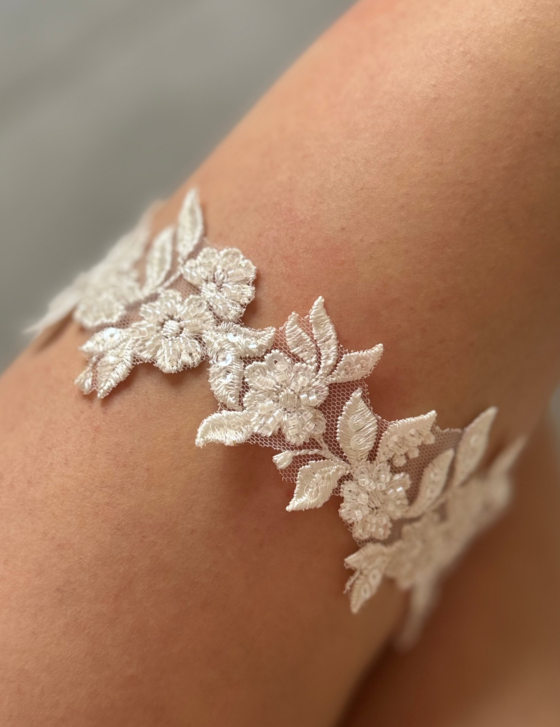 Floral beaded lace garter on bride