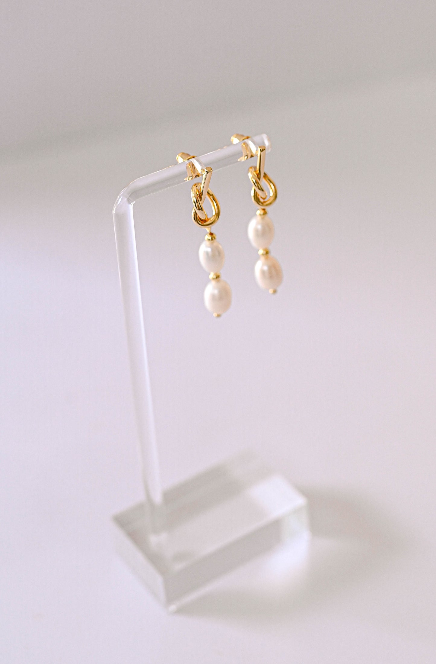Gold knot bridal earrings with two freshwater pearls.