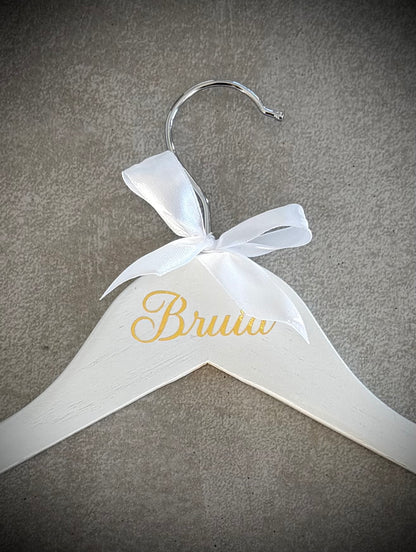 White wooden hanger with gold Bruid vinyl and a white ribbon bow
