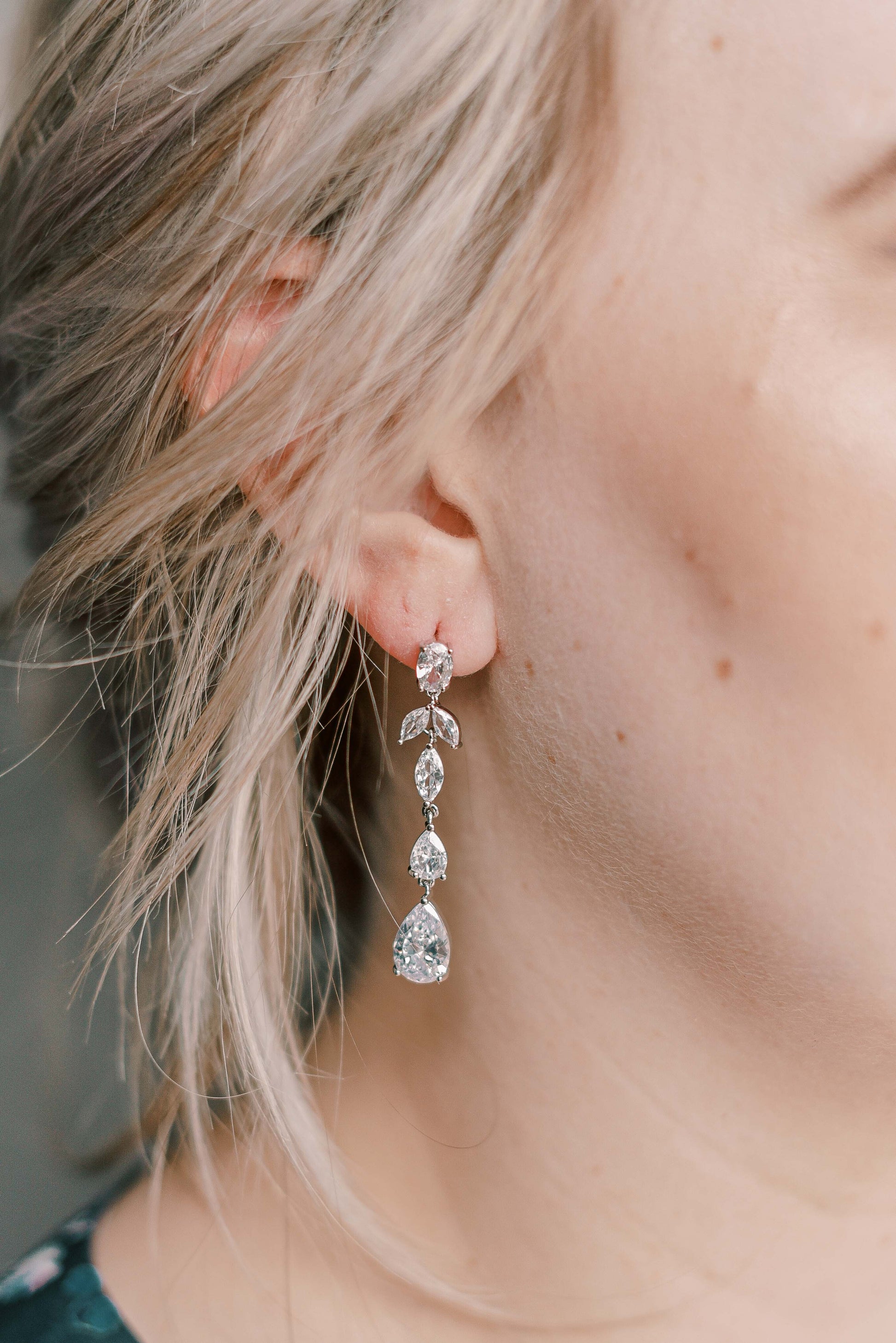 Bride wearing dangling cubic zirconia earrings