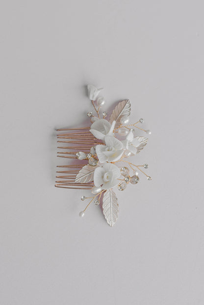 Rose gold bridal hair comb with porcelain flowers and leaf detail