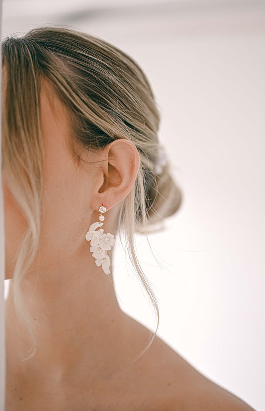 Bride wearing a cluster of porcelain flowers earring