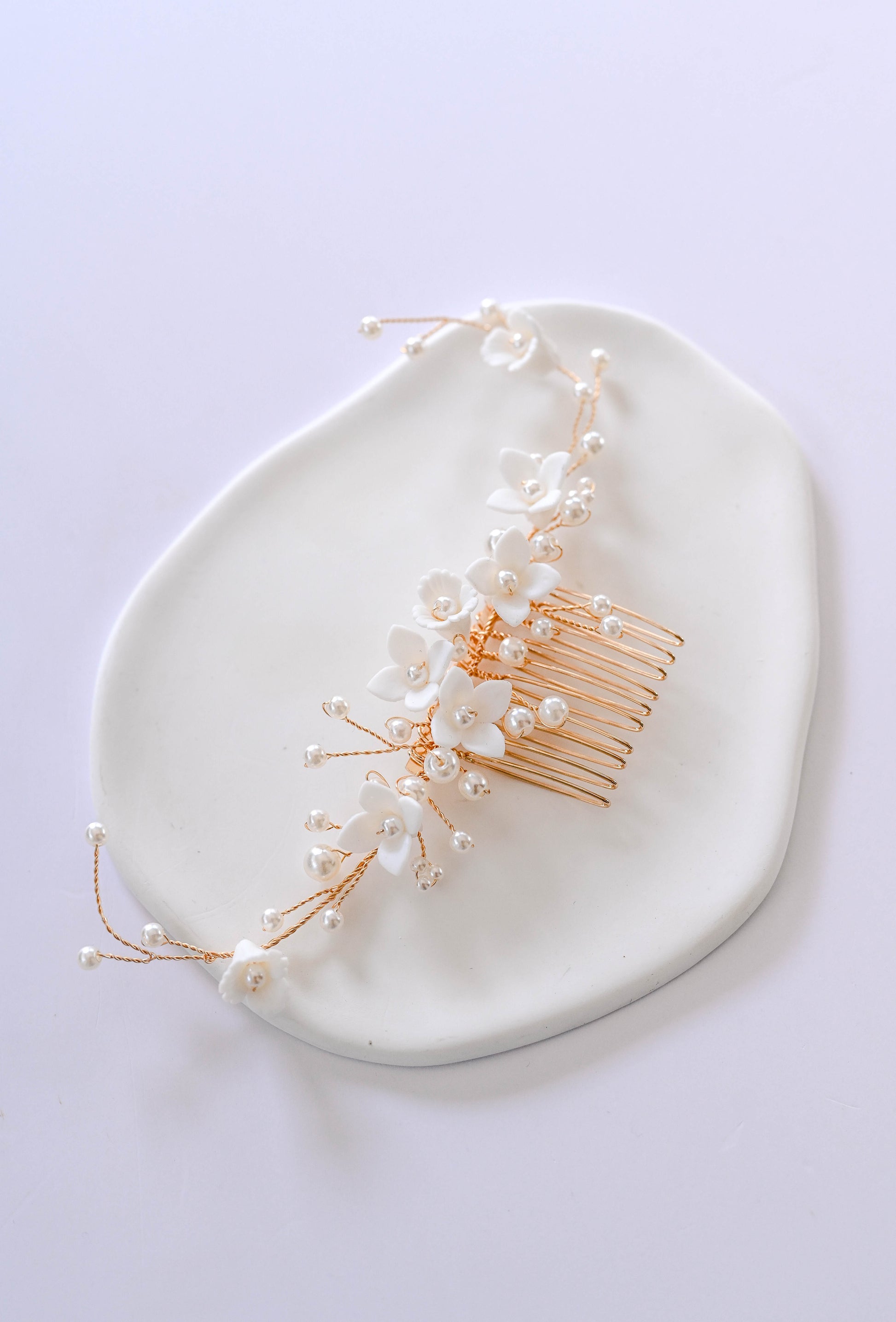 Gold Bridal hair comb with porcelain flowers and faux pearls.