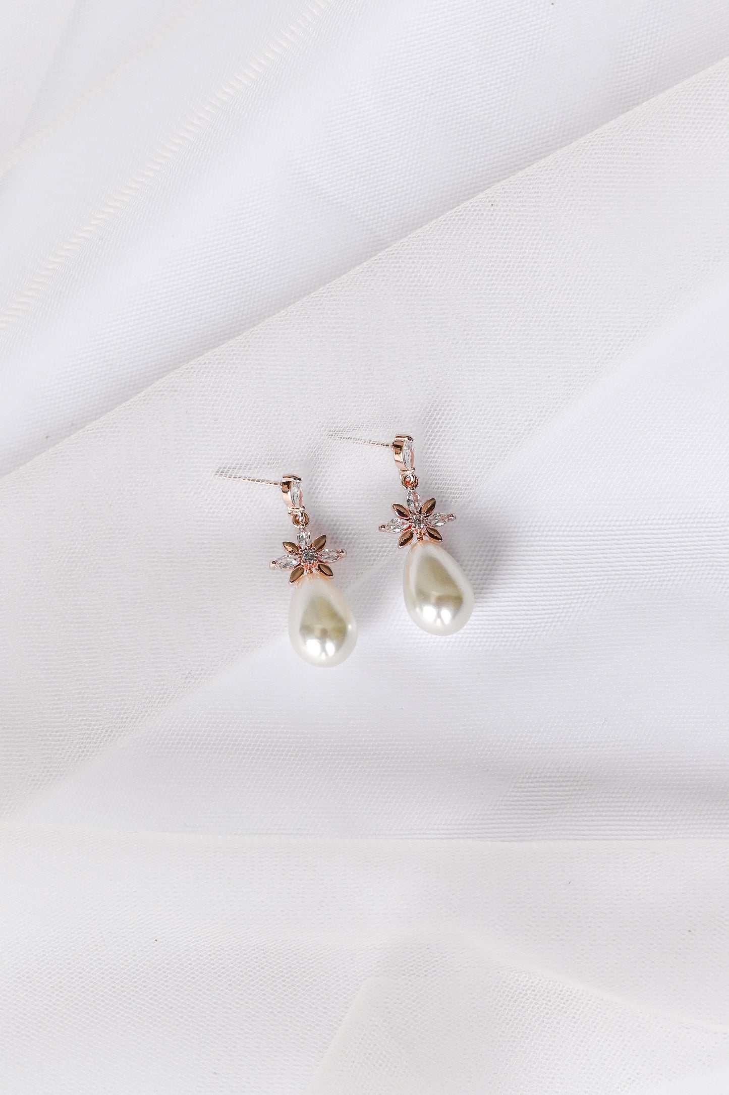 Rose gold bridal earrings with cubic zirconia and a faux pearl