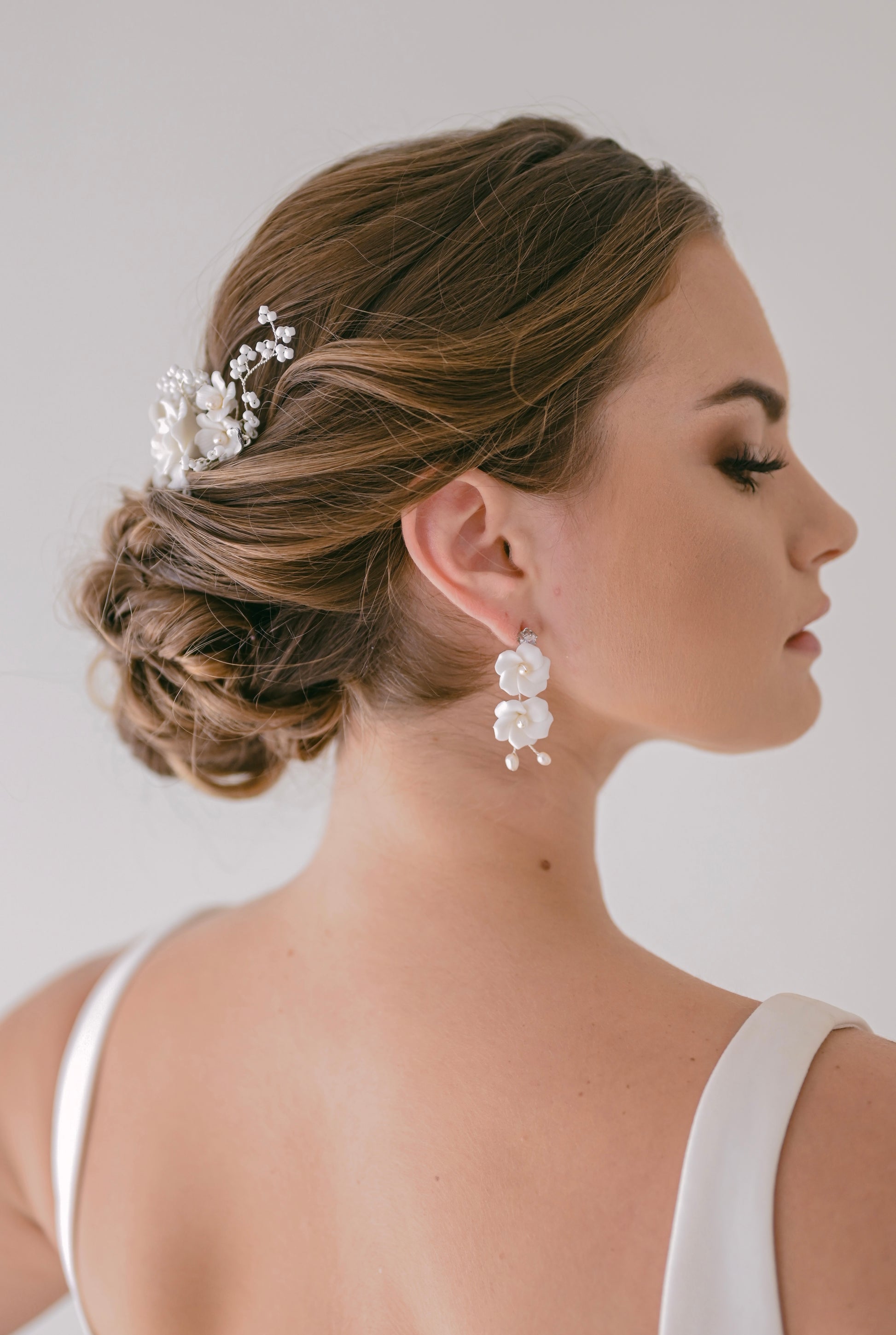 Bride wearing porcelain flower earring with fresh water pearls