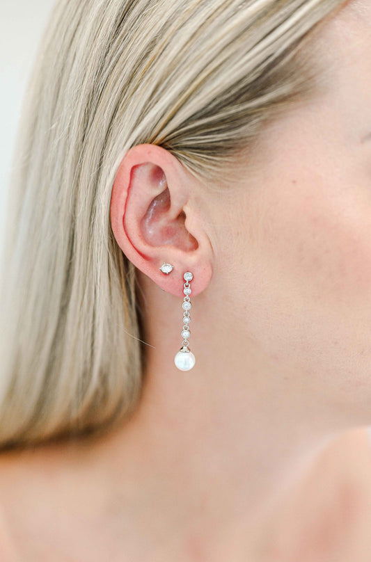 Bride wearing a dainty cubic zirconia drop earring with a faux pearl