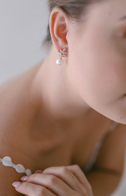 Bride wearing cubic zirconia and faux pearl drop earring