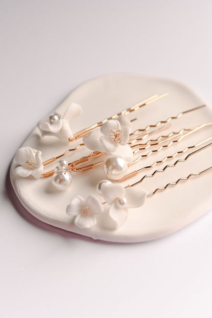 A set of 6 rose gold hair pins with porcelain flowers and pearls