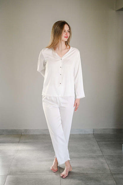 Bride wearing a long sleeve silk pajama set with heart detail on trim.