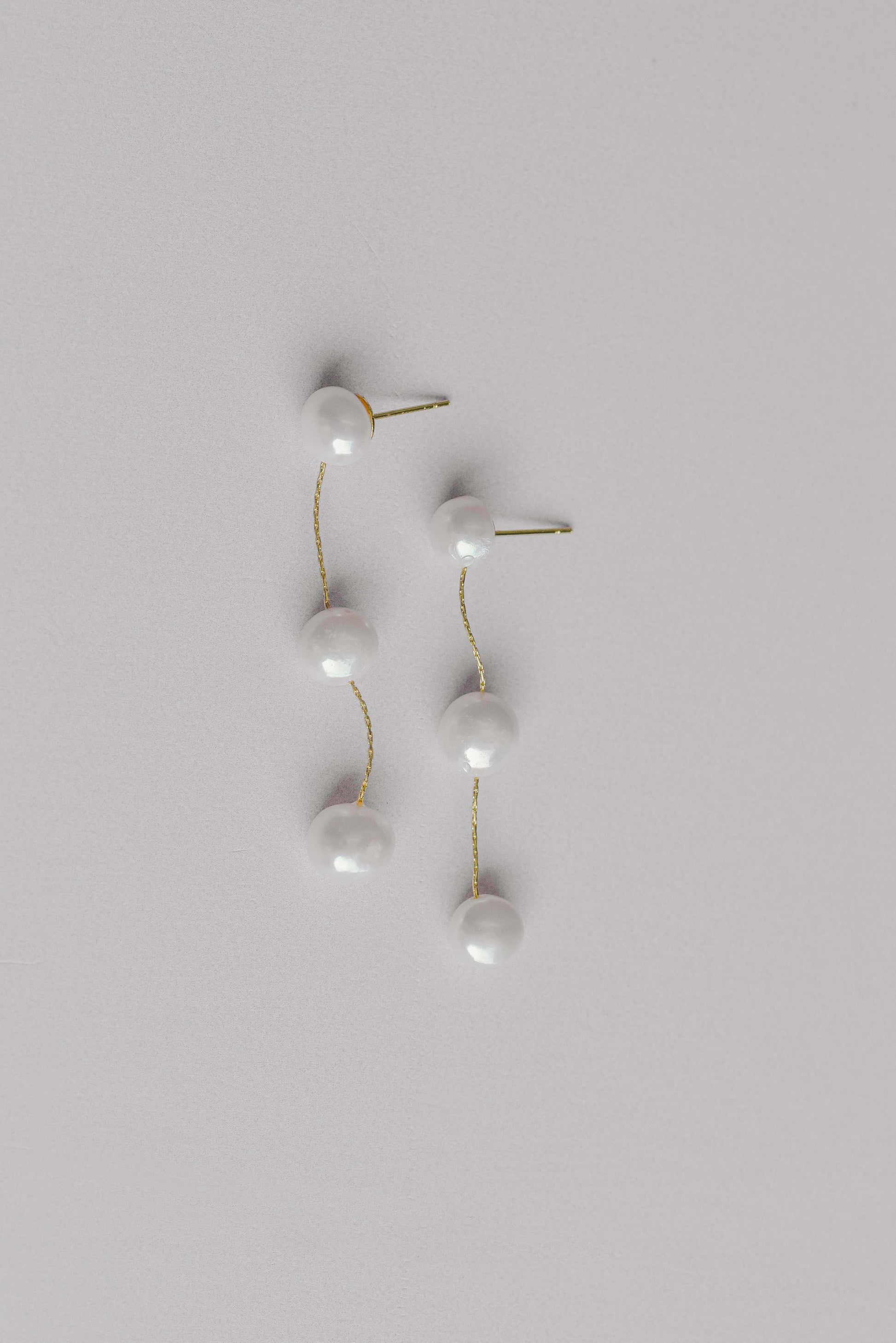 Gold bridal earrings with a string of 3 fresh water pearls