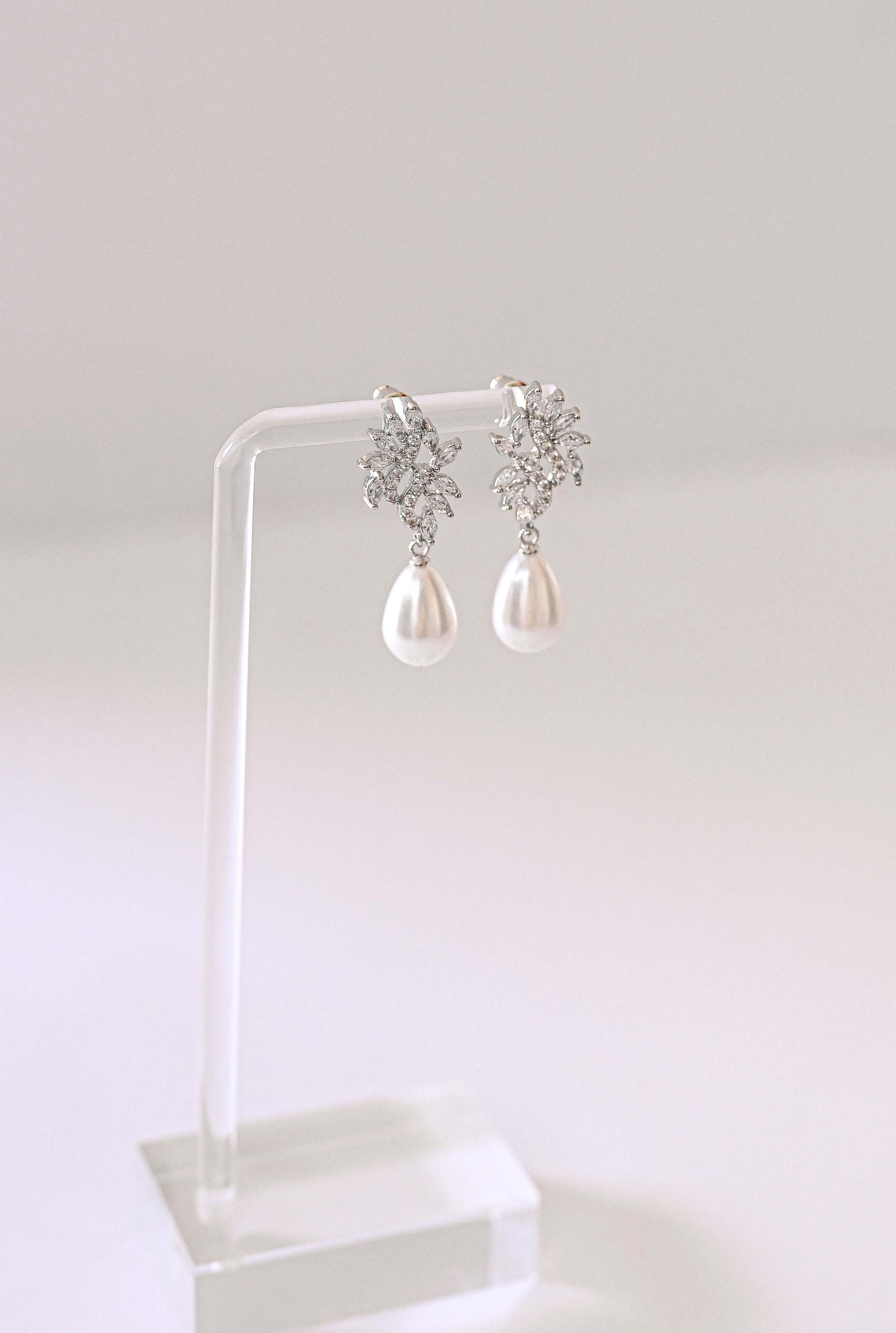 Silver bridal earring with cubic zirconia and a faux pearl.