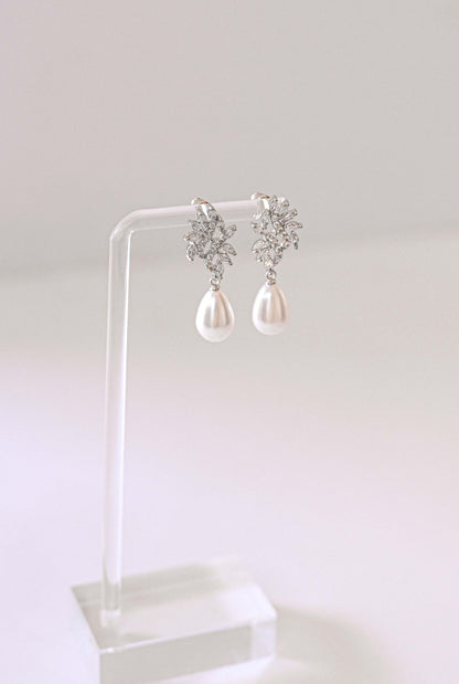 Silver bridal earring with cubic zirconia and a faux pearl.
