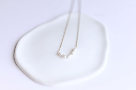 Stainless steel, 18K Gold plated necklace with 5 freshwater pearls.