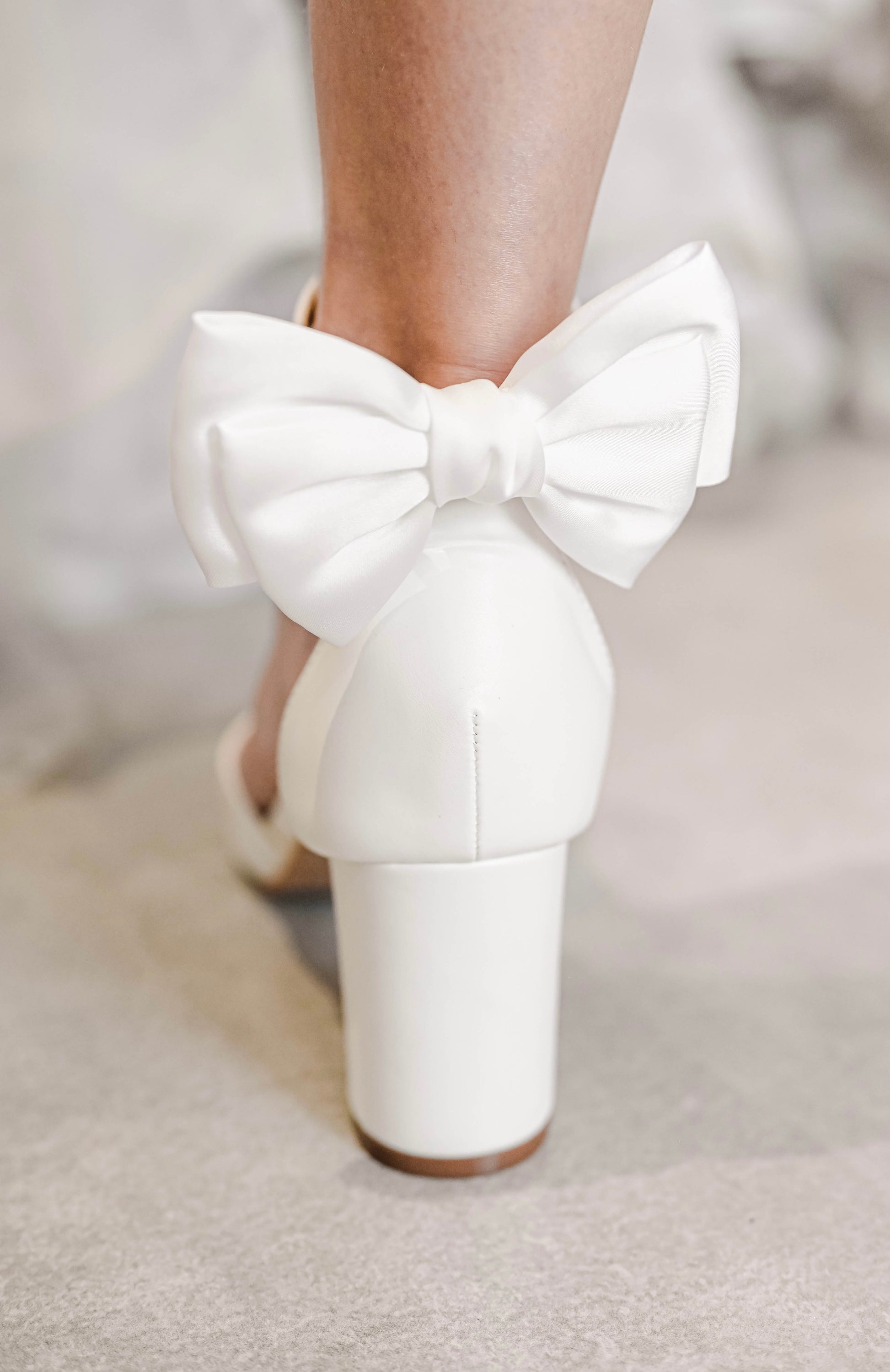 Bridal shoe with satin bow clip at back