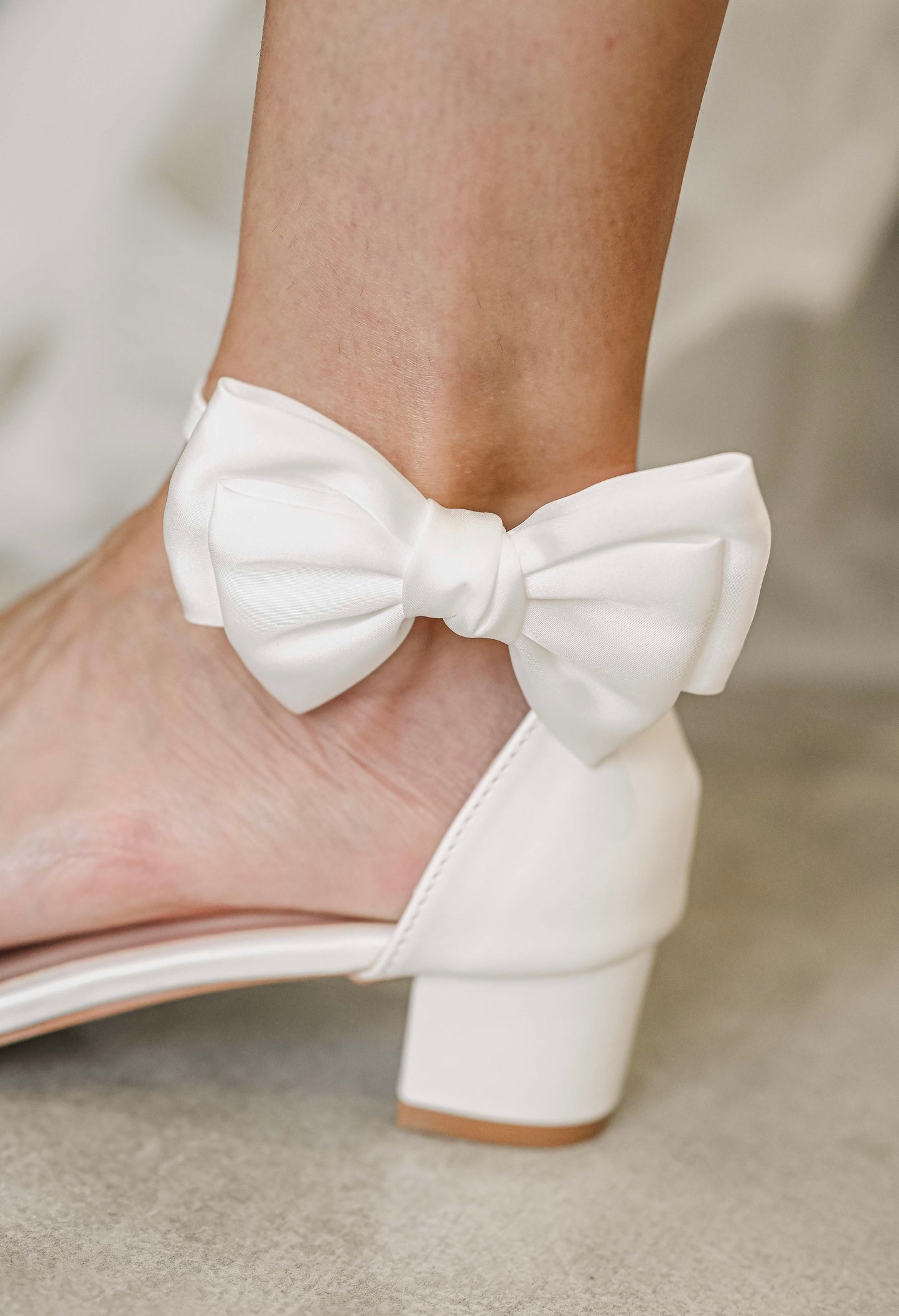 Bridal shoe with satin bow clip on the side