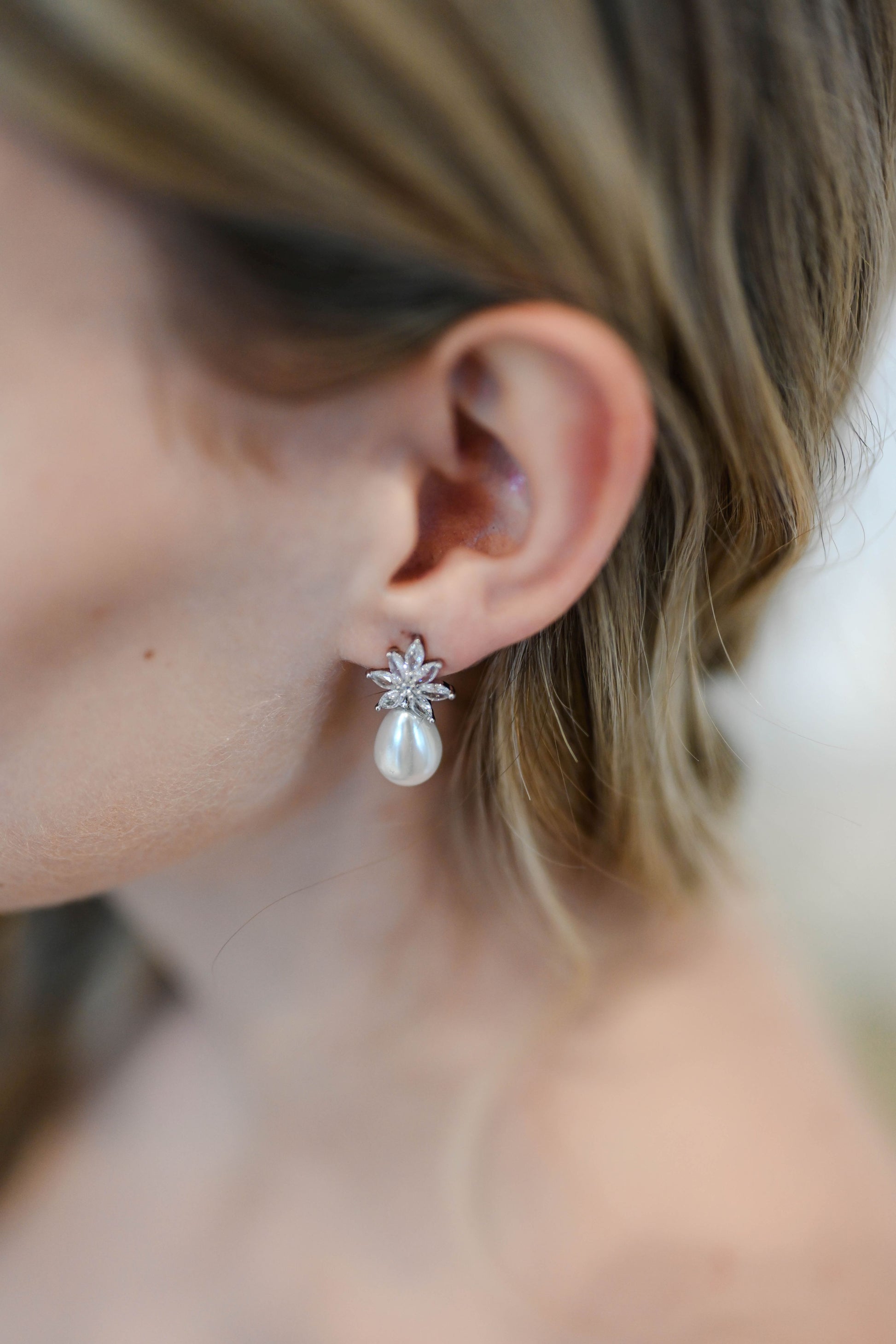 Bride wearing cubic zirconia earrings with a teardrop pearl