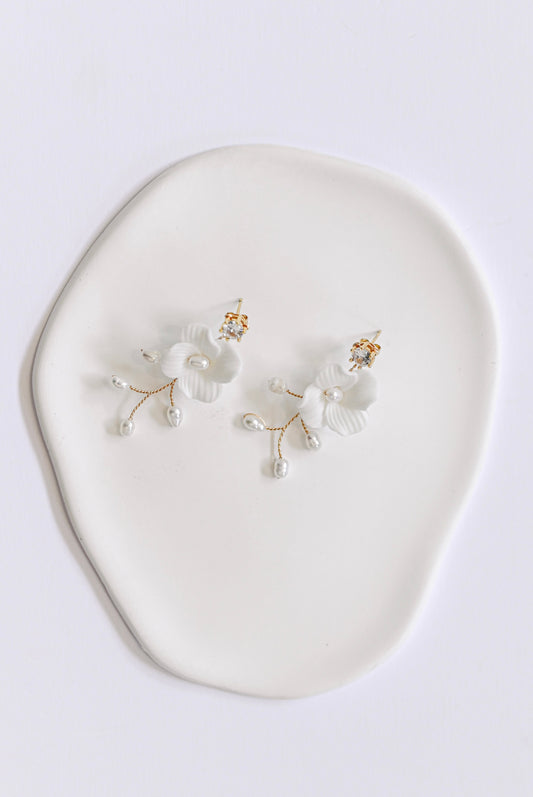 Gold bridal earring with single porcelain flower and fresh water pearls.