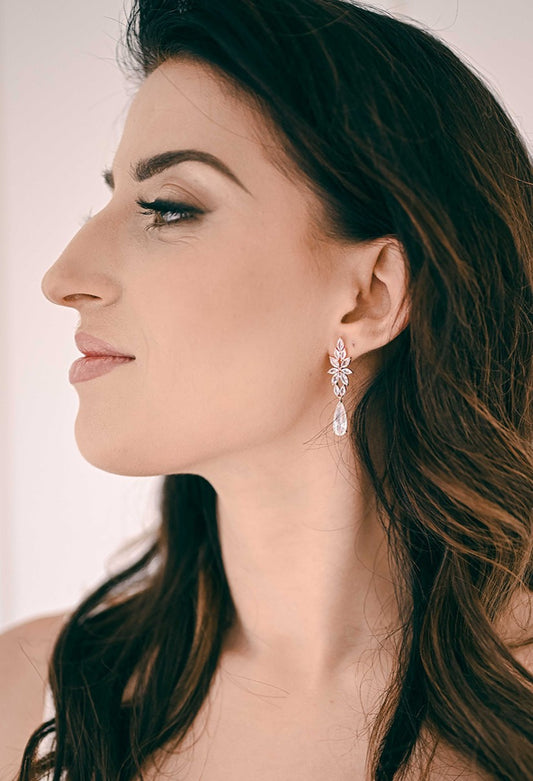 Bride wearing cubic zirconia dangling earring in rose gold