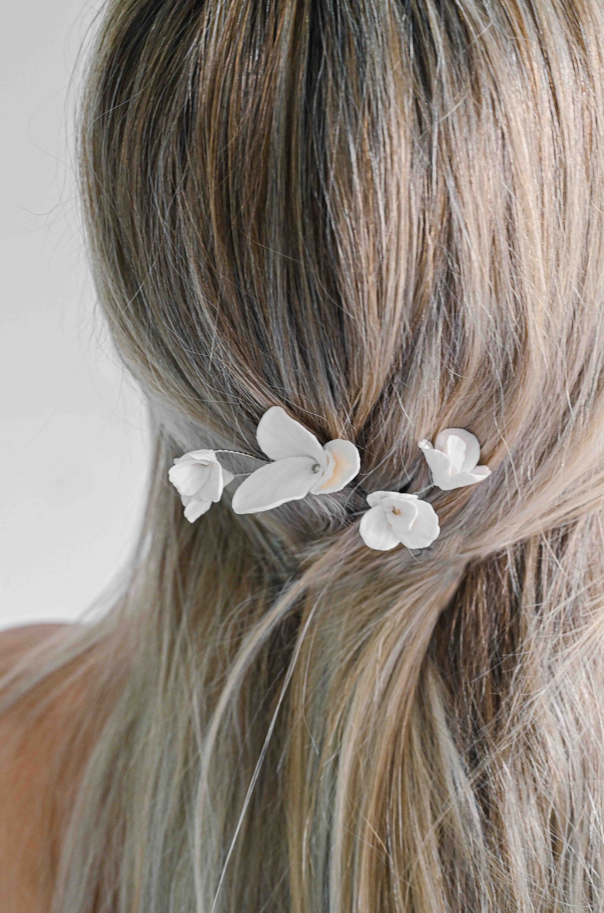 Bride wearing hairpins with handmade clay flowers