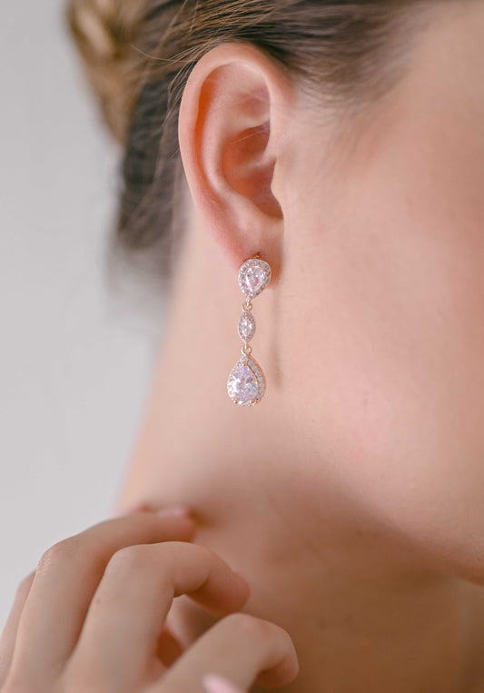 Bride wearing rose gold cubic zirconia drop earrings