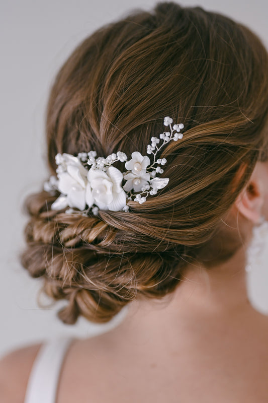 Bride wearing porcelain flower bridal hair comb with fresh water pearls and beads